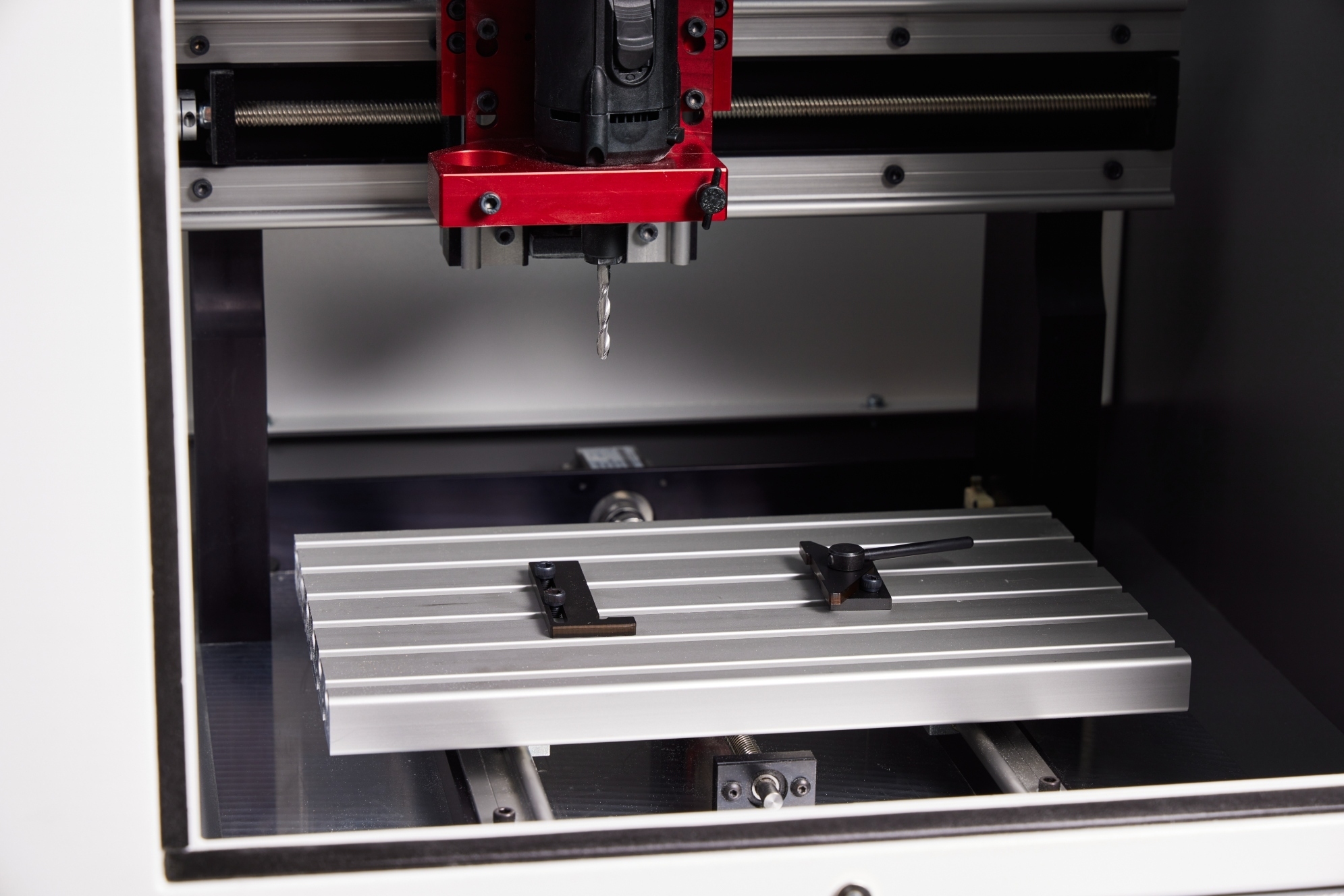 Work holding fixture and material positioned beneath the spindle