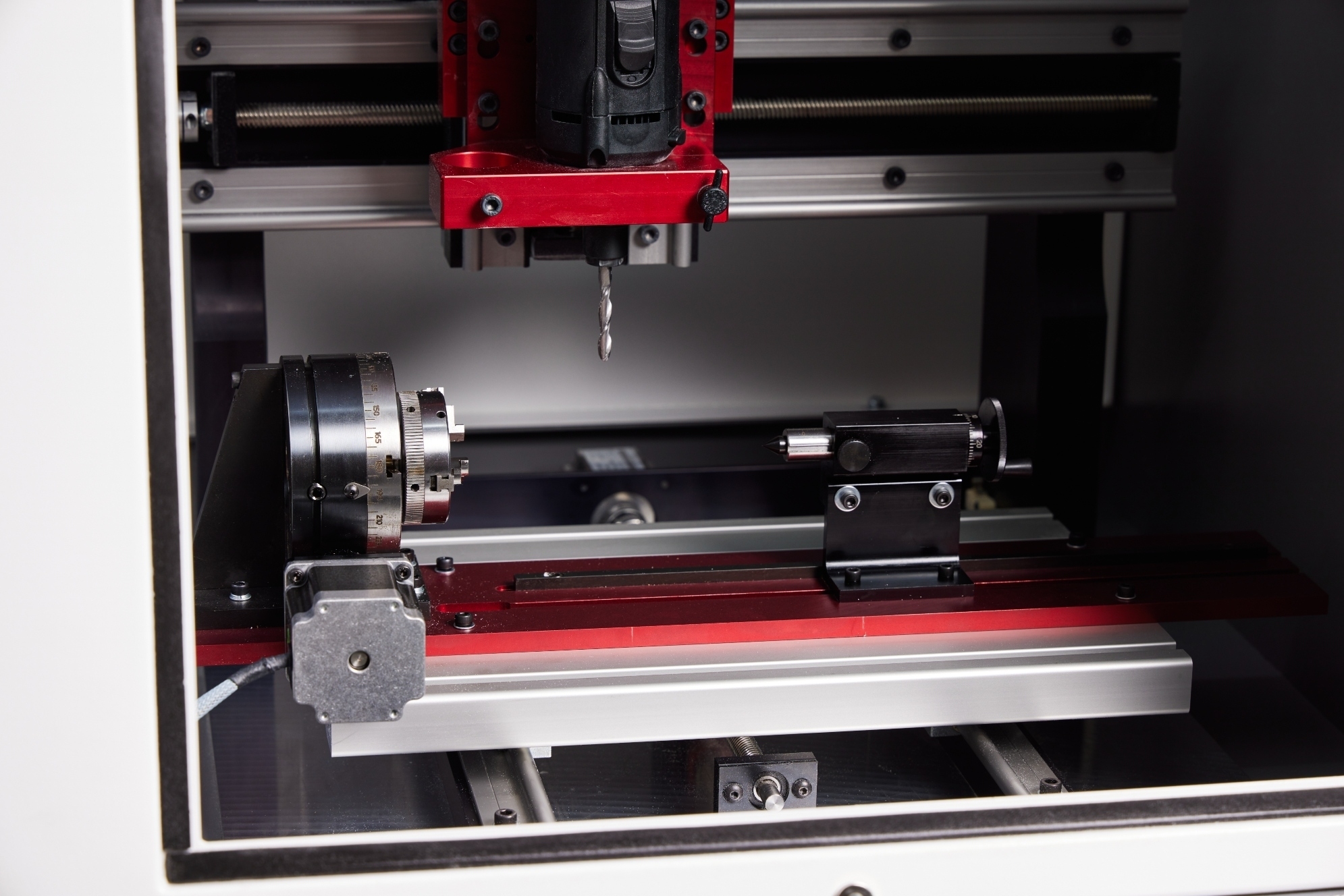Compact 1000 fourth-axis rotary fixture positioned beneath the CNC spindle
