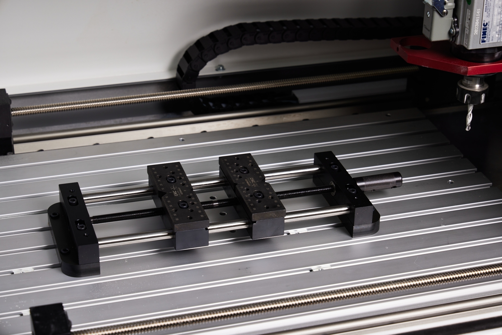 Two work holding fixtures mounted side by side on the Router 2600 T-slot table